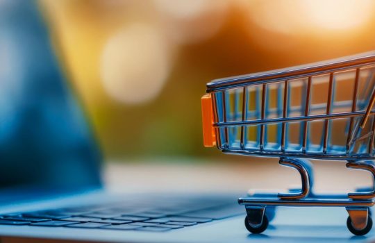 Small shopping cart on a laptop keyboard, illustrating online shopping. (informative)