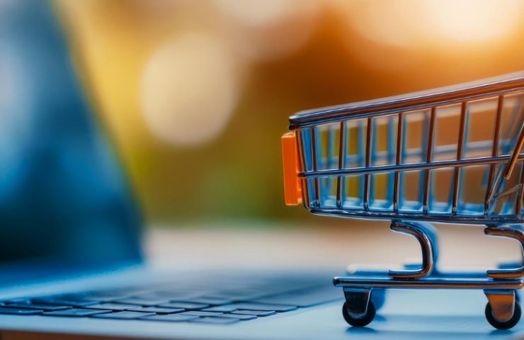 Small shopping cart on a laptop keyboard, illustrating online shopping. (informative)